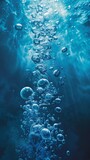 Underwater bubble stream in deep blue ocean