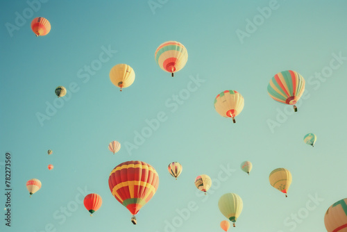A bunch of hot air balloons are flying in the sky
