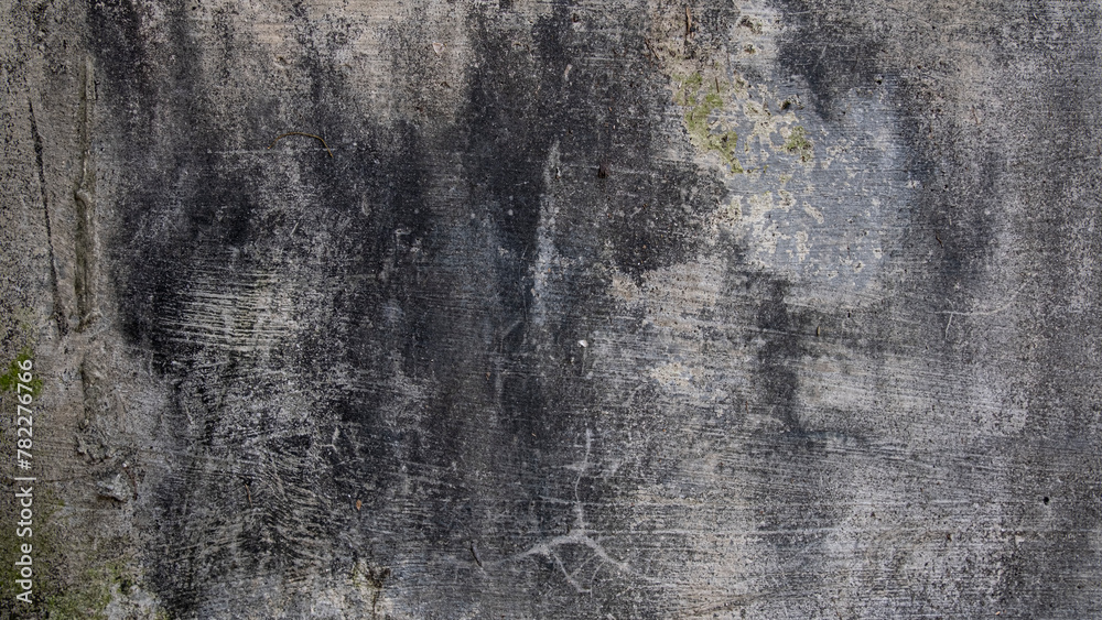 Grey concrete wall with black mildew stains