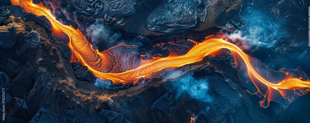 Aerial view of molten lava river flowing through volcanic terrain