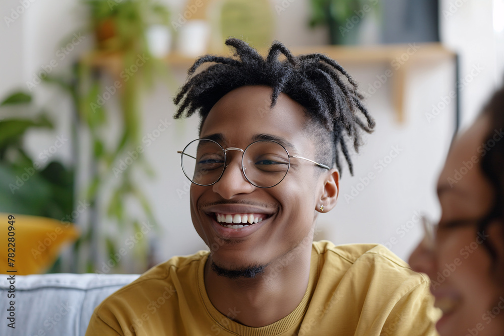 Smiling Young Man with Trendy Hairstyle and Glasses Enjoying Conversation Smiling Young Man with Trendy Hairstyle and Glasses Enjoying Conversation