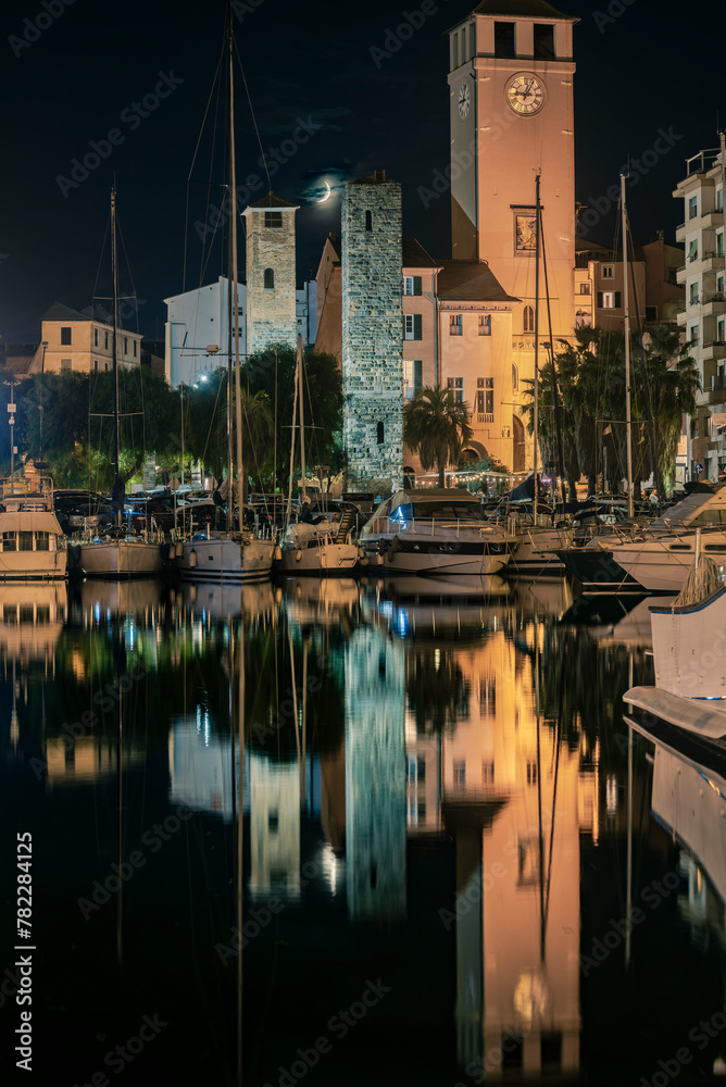 The medieval Savona harbor, with its old and new towers at night.
