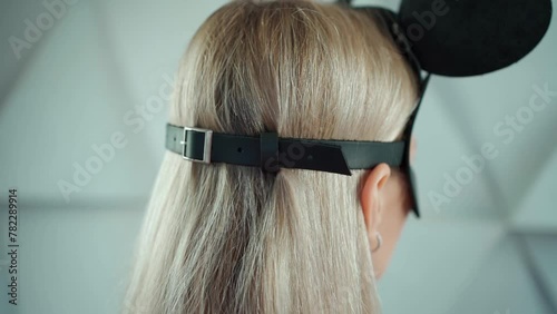 back view of woman in black role play game mouse mask, female in kinky leather accessory, role play games