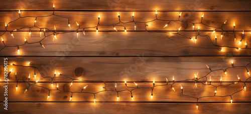 Christmas Light on Wooden Background Top View with Copyspace. Garland Lights on Vintage Wood Texture