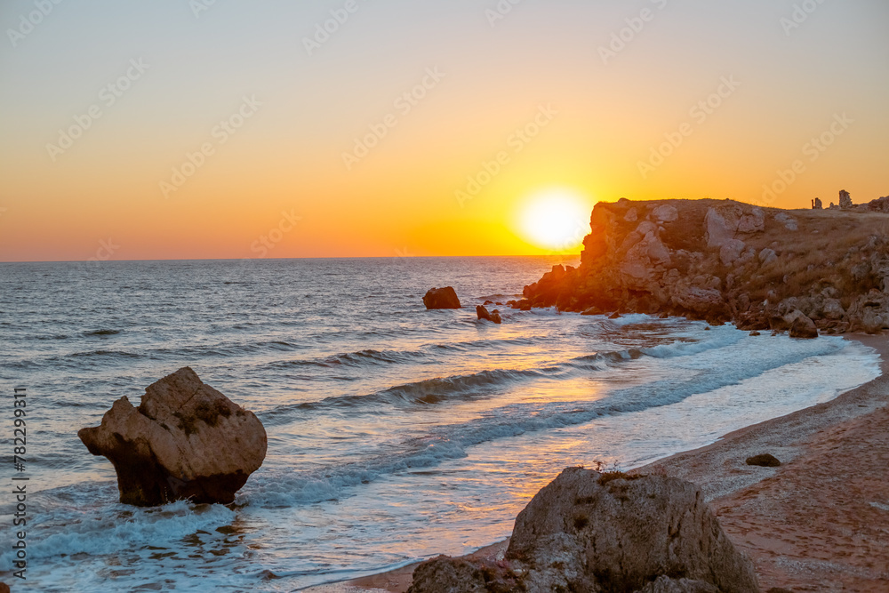 Beautiful seascape. Dawn over a mountain on the seashore in Crimea