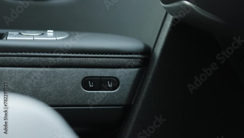 Control buttons for settings and memory of the driver's seat, electric glass opening, door handle in the interior of the new luxury electric car. Driver's seat adjustment buttons photo