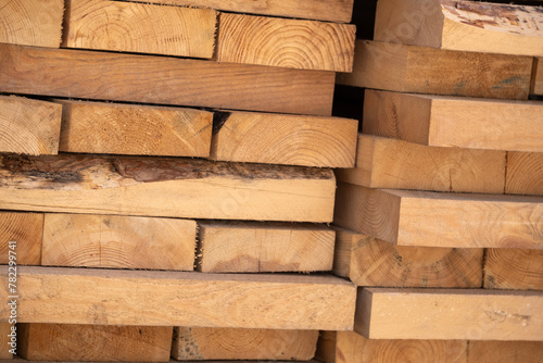 Wooden boards of different sizes are stacked in a pile. Background.