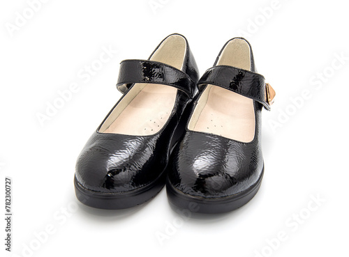 Pair of little black girl's shoes isolated on the white background.