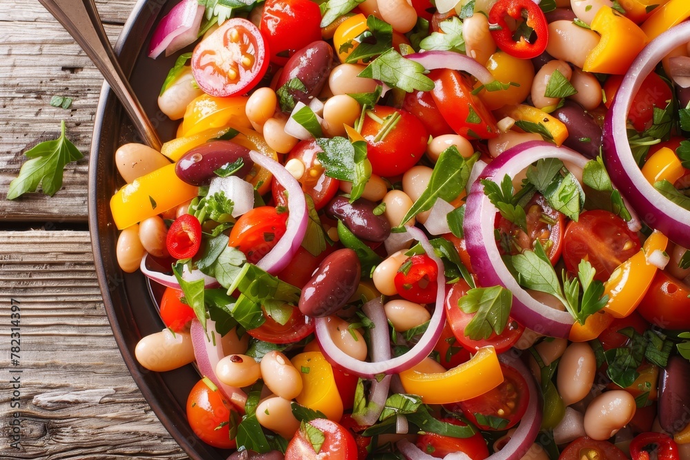 Close up homemade salad with beans tomatoes onions peppers and herbs on a table Top view Close up homemade salad with beans tomatoes onions peppers and herbs on a table Top view