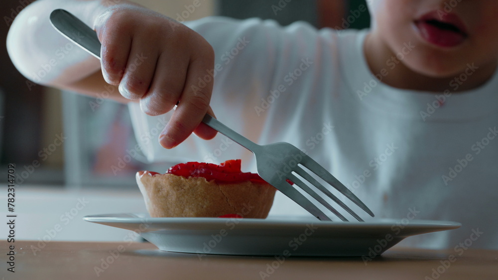 Child Struggling to Reach Cheesecake with Fork - Close-Up View of Sugary Treat Topped with Strawberries on Plate