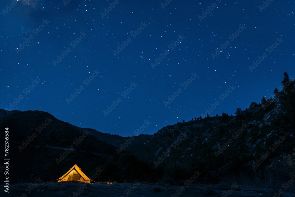 Tent glowing under mountain stars Tent glowing under mountain stars
