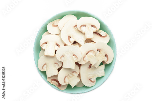 Fresh white champignon mushrooms on mint plate isolated on white background.
