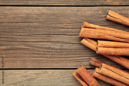 Overhead view of cinnamon sticks dried tree bark spice. Cinnamon on grey wooden background