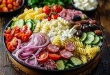 Italian pasta salad with cucumbers cherry tomatoes olives red onion salami feta cheese and Rotini