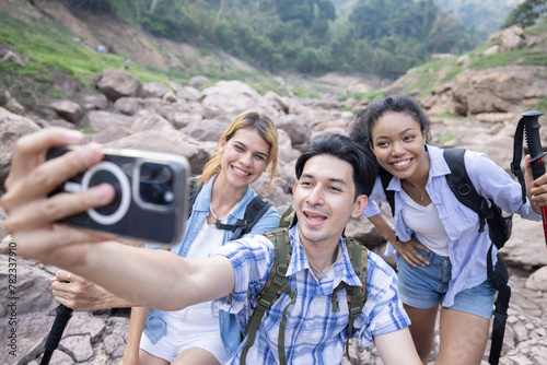 Friends taking selfie while trekking on the mountain