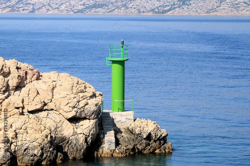 green lighthouse by arriving the island Rab by ferry, Croatia