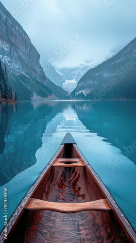 A sleek canoe gliding through a misty morning on a calm mountain lake, reflecting the surrounding peaks. Vertical screensaver wallpaper for smartphone. 