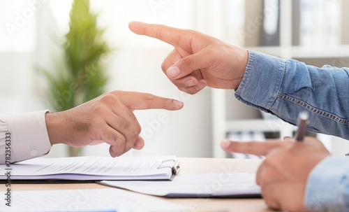 Two hands pointing fingers at each other over paper
