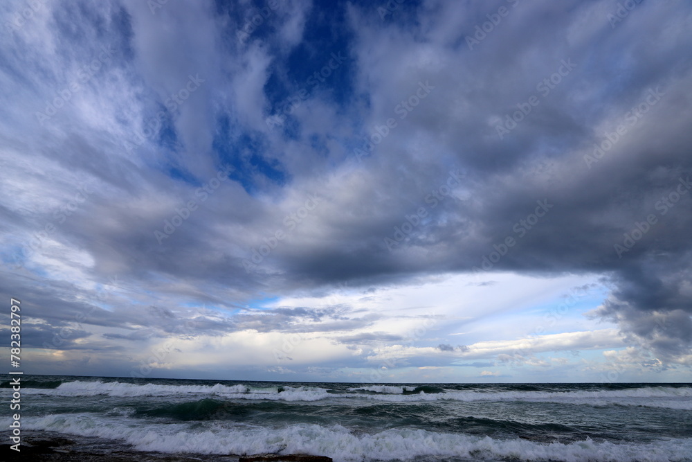 Rain clouds in the sky over the Mediterranean Sea.