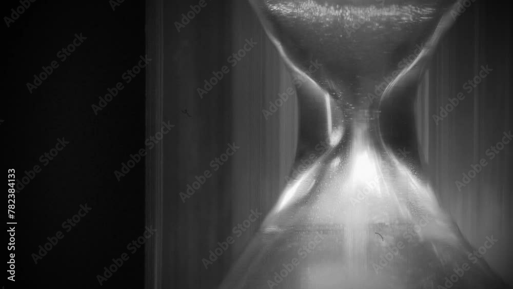 Time flows backwards, in opposite direction. Sand in hourglass. Time cures all things. Time is great healer. 4K Slow Motion time reversed video in retro style, old filming