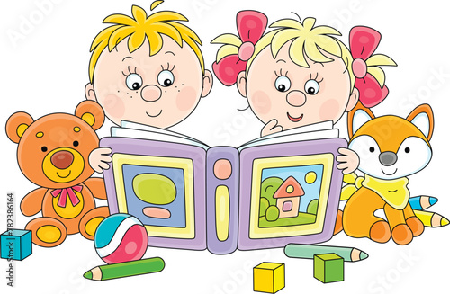 Funny little boy and girl reading an interesting book of fairy tales among their toys in a nursery room, vector cartoon illustration isolated on a white background