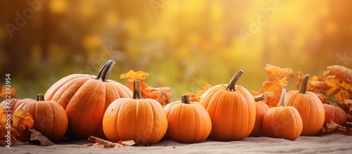 Pumpkins scattered on foliage-covered table
