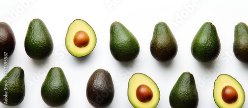 Fresh group of avocados on a white surface