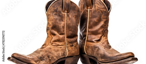 Old rugged cowboy boots on a plain background