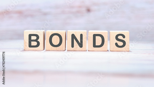 Bond indices on wooden cubes on an abstract background