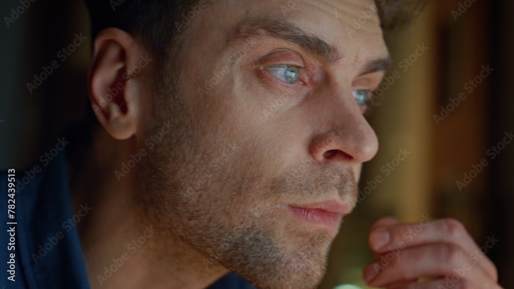 Obraz premium Focused man staring screen at night flat closeup. Guy hands typing keyboard