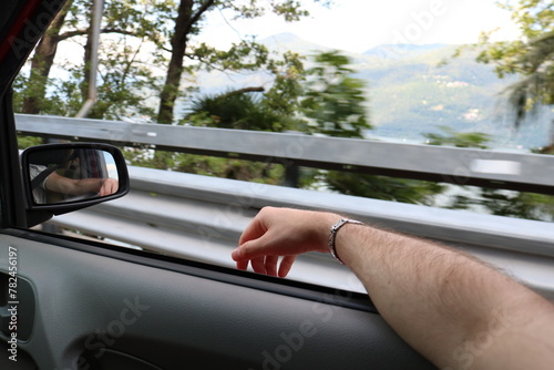 Man resting hand out of car window. Freedom and holiday concept. 