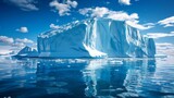A large iceberg, likely from Antarctica, floats in the vast expanse of the ocean. The icebergs pristine geometric forms create a striking contrast against the surrounding water.