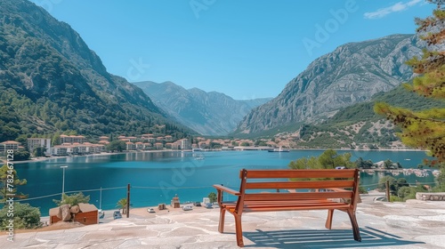 Wooden bench overlooking lake mountains, surrounded by natures beauty © Katsiaryna