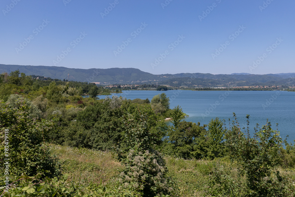 Fototapeta premium The Bilancino Lake. Lago di Bilancino, Barberino del Mugello, Florence, Italy: landscape at dawn of the picturesque lake in the Tuscan hills