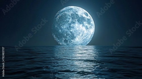 A large  bright moon is seen over a dark sea  reflecting the moon s light. The sky is a deep blue with a few stars scattered throughout.