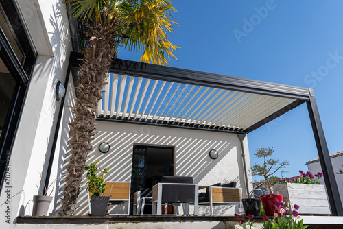 eco friendly bioclimatic aluminum pergola shade structure surrounded by landscaping