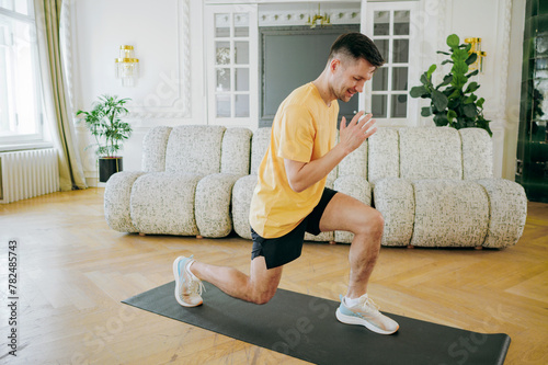Man engaged in a dynamic lunge workout on a mat, fusing fitness and comfort in an elegant home setting.
