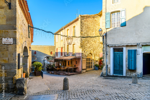 A picturesque street and alley of shops and sidewalk cafes in the La Cite' medieval old town inside the castle at Carcassonne, France.
