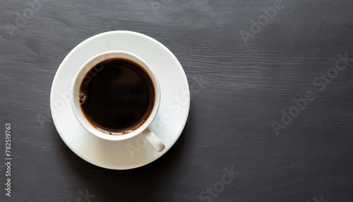 Cup of coffee on black background. Top view. Copy space.