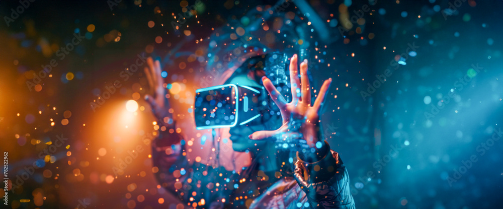 Obraz premium A person adorned in a dark jacket uses a VR headset, hands reaching out, amidst a swirl of glittering, digital particles suggesting an immersive virtual experience. Banner. Copy space