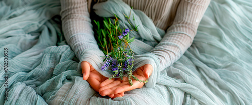 Serene scene of hands gently holding fresh lavender over a soft, draped fabric, invoking tranquility and the beauty of simple moments. Organic Bio Cosmetics. Herbal teas. Banner. Copy space