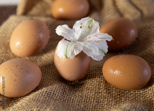 The eggs lie on burlap. Background with eggs with flower