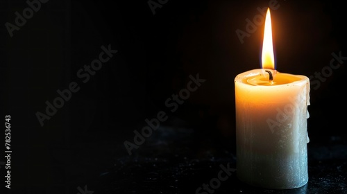 cute lit candle on black background