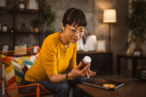 Japanese mature woman read recipe for medicament use tablet at home