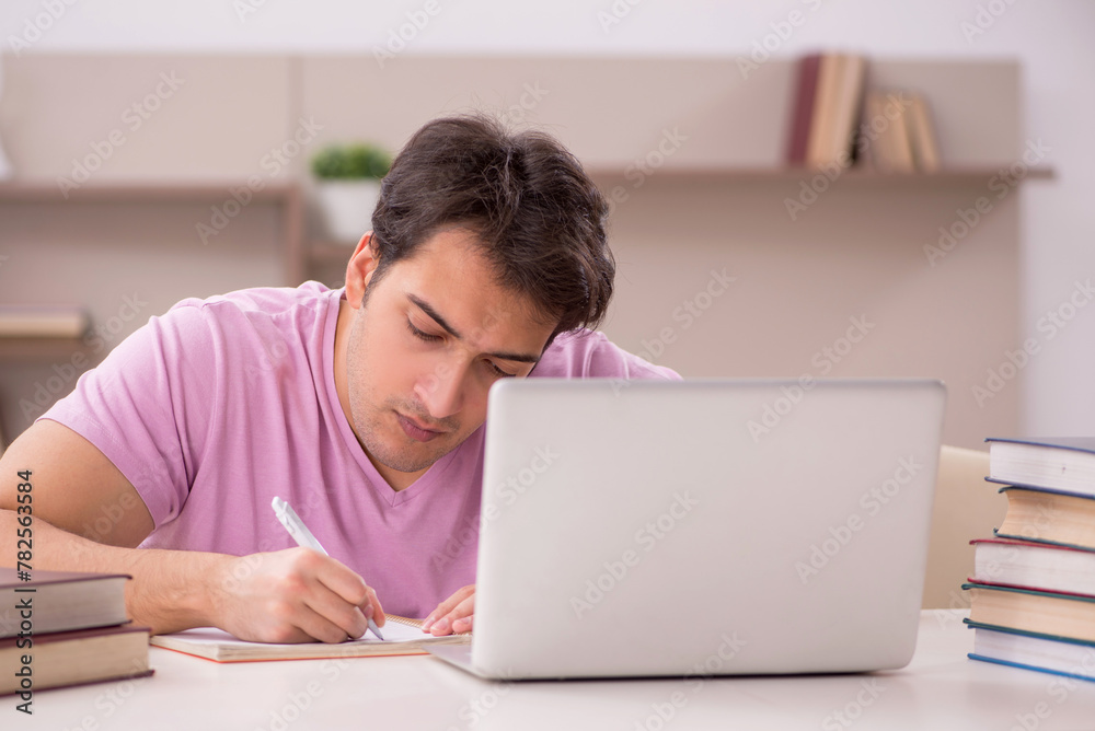 Young male student preparing for exams at home Young male student preparing for exams at home