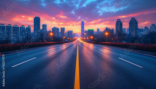 The perspective of the road against the background of sunset and the cityscape