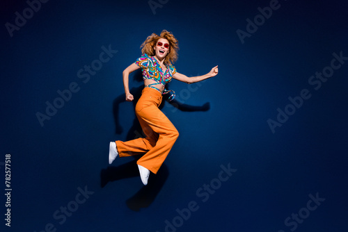 Full body profile portrait of nice young lady jump run empty space wear top isolated on dark blue color background