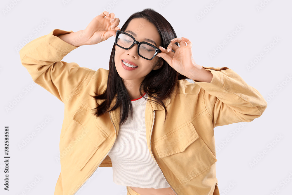 Young Asian woman in eyeglasses on white background Young Asian woman in eyeglasses on white background