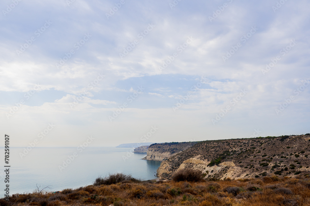 Landscape with huge rocks and view on small village near the sea in Cyprus