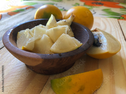 Abiu fruit cut in wooden bowl and served in dessert photo